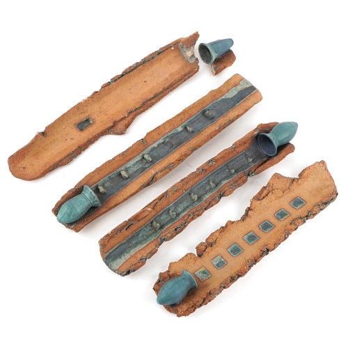 477 - Jini Hedblom, a set of four Swedish studio pottery wall hanging candlesticks, 45cm high.