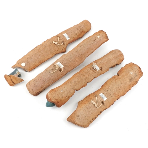 477 - Jini Hedblom, a set of four Swedish studio pottery wall hanging candlesticks, 45cm high.