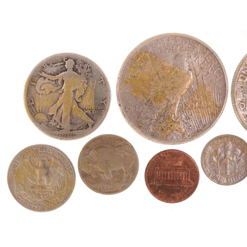 1078 - A small quantity of silver and white metal American coinage including two silver Liberty dollars dat... 