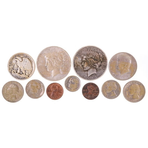 1078 - A small quantity of silver and white metal American coinage including two silver Liberty dollars dat... 