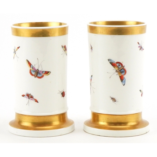 35 - A pair of 19th century, possibly Nantgarw, porcelain spill vases, each hand painted with a bird perc... 