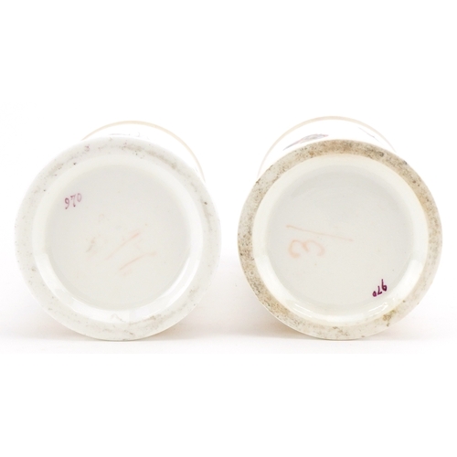 35 - A pair of 19th century, possibly Nantgarw, porcelain spill vases, each hand painted with a bird perc... 