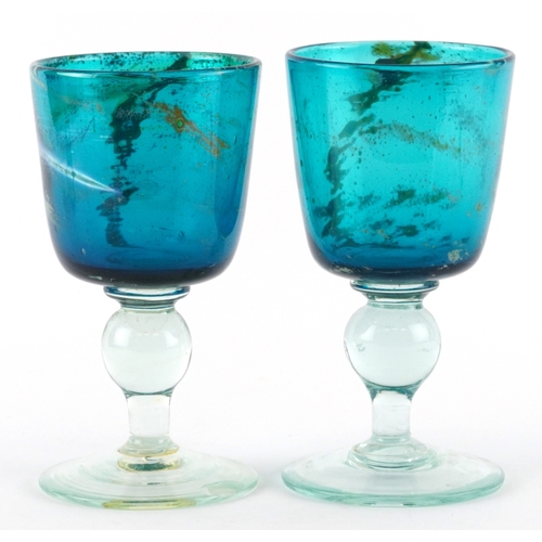 169 - Two blue swirling glass goblets, one etched Mdina to the base, the largest 17cm high.