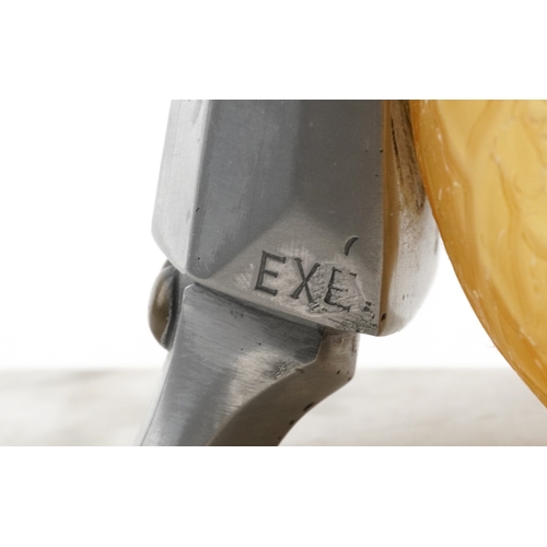  An Art Deco aluminium and glass Pierrot figural table lamp with amber frosted glass shade, raised on... 