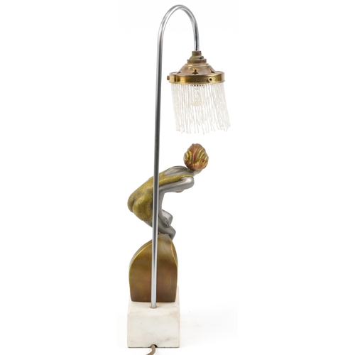 210 - An Art Deco style table lamp in the form of a female figure raised on a marble base, 52cm high.