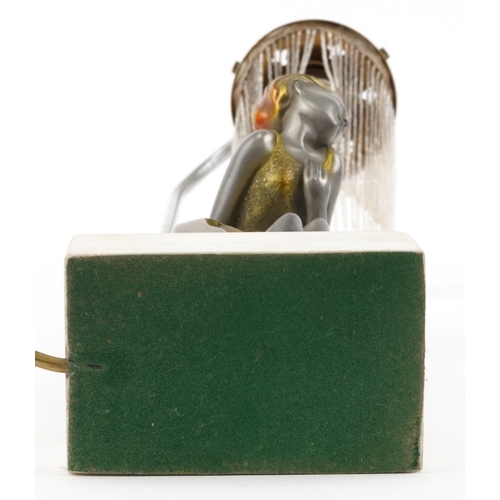 210 - An Art Deco style table lamp in the form of a female figure raised on a marble base, 52cm high.