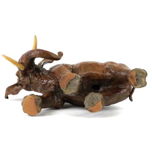 479 - An early 20th century Tole painted spelter model of a standing elephant, 33cm high x 55cm wide.