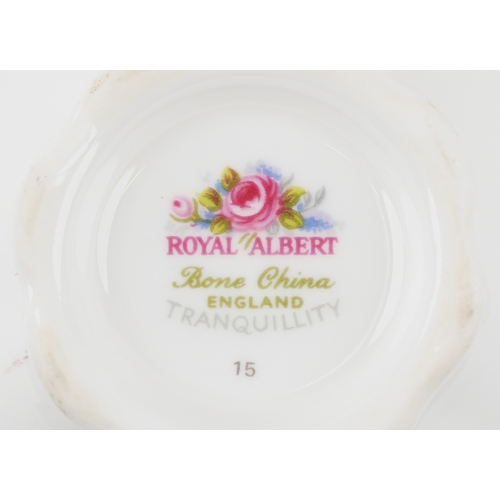 652 - A Royal Albert tea service in the Tranquility pattern including a teapot and two trios, the largest ... 