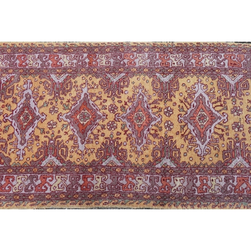 2205 - A Indian runner, late 20th century, the mustard field with a central row of medallions within a comp... 