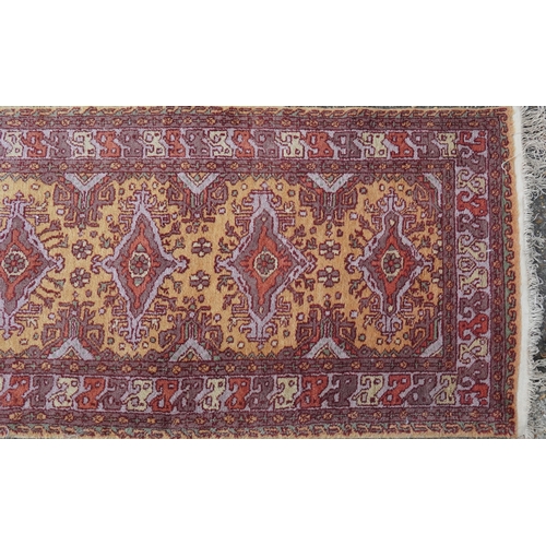 2205 - A Indian runner, late 20th century, the mustard field with a central row of medallions within a comp... 