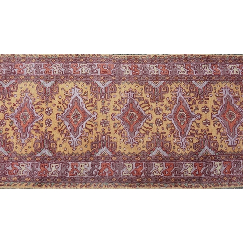 2205 - A Indian runner, late 20th century, the mustard field with a central row of medallions within a comp... 