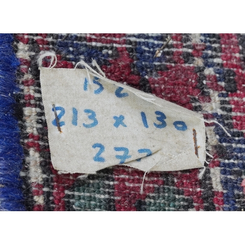 2221 - A Hamadan rug, North West Persia, mid 20th century, the red field with a stylized central medallion ... 