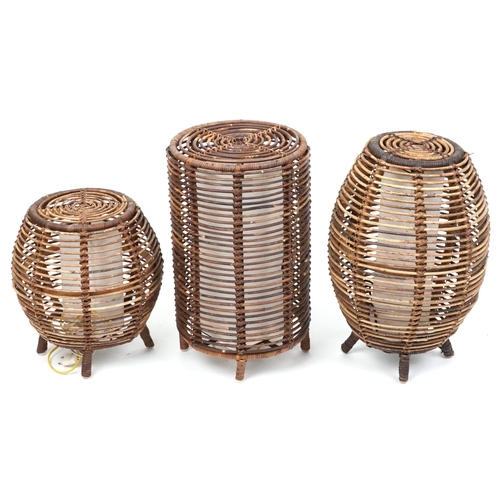 2144 - Three similar mid/late 20th century wicker floor lamps after a design by Tito Agnoli, the largest 52... 