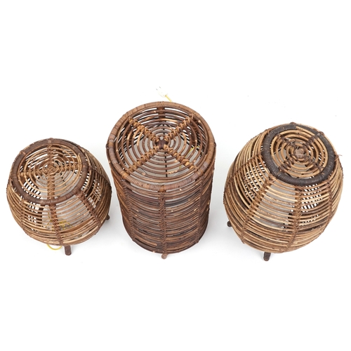 2144 - Three similar mid/late 20th century wicker floor lamps after a design by Tito Agnoli, the largest 52... 
