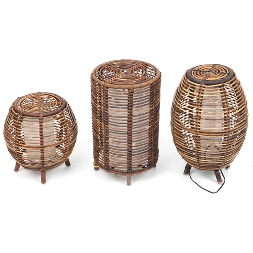 2144 - Three similar mid/late 20th century wicker floor lamps after a design by Tito Agnoli, the largest 52... 