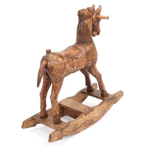 697 - An Eastern carved hardwood rocking horse, 91cm H x 96cm W x 31cm D.