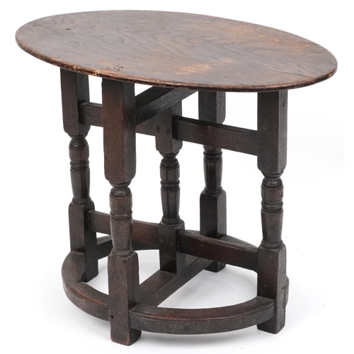 2150 - A late Victorian oak oval occasional table raised on turned and block supports, 59cm H x 72cm W x 46... 