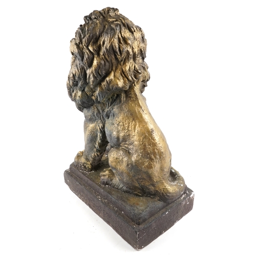473 - A large painted plaster sculpture of a seated lion raised on a plinth base, 66cm high.