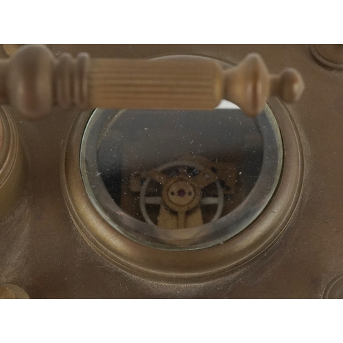 134 - A champlevé enamel brass cased travelling timepiece with clock and barometer, 14cm high.