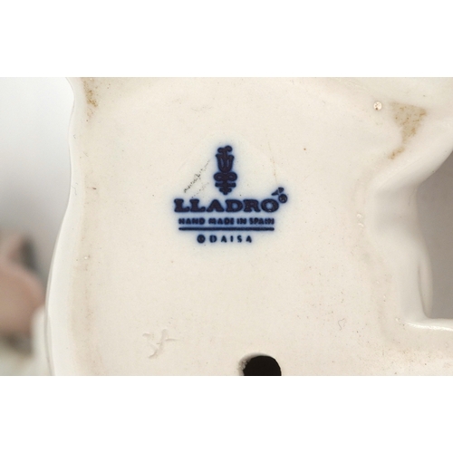 601 - Two Lladro porcelain models of dogs, D-13N, AOE, the largest 18cm in length.