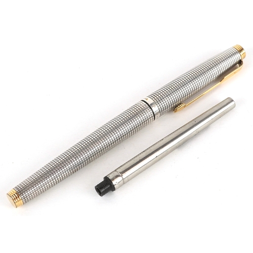 64 - Parker, a sterling silver engine turned fountain pen with 14K gold nib, 13cm in length.