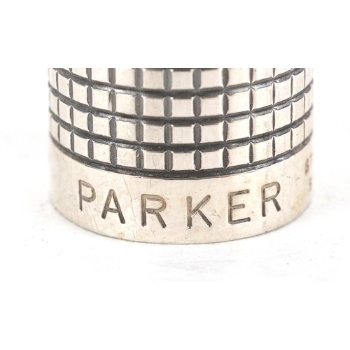 64 - Parker, a sterling silver engine turned fountain pen with 14K gold nib, 13cm in length.