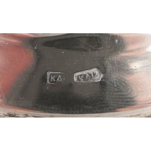 45 - A pair of 830 grade Cyprus silver candlesticks with embossed decoration, KAL maker's mark, 18.5cm hi... 