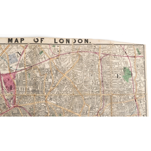 1321 - An early 20th century Reduced Ordnance Map of London housed in a hardback book, 67cm x 90cm.