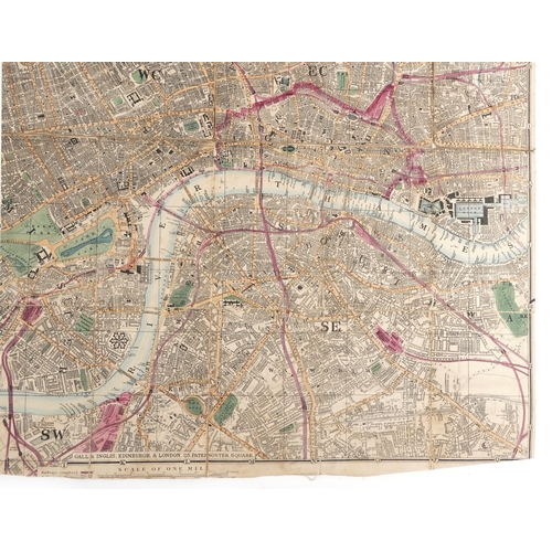 1321 - An early 20th century Reduced Ordnance Map of London housed in a hardback book, 67cm x 90cm.