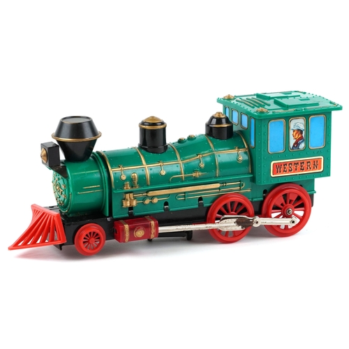 722 - A Marx whistling lighted piston locomotive battery operated plastic toy train, 33cm wide, boxed.