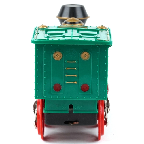 722 - A Marx whistling lighted piston locomotive battery operated plastic toy train, 33cm wide, boxed.
