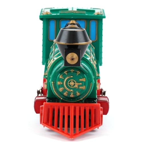 722 - A Marx whistling lighted piston locomotive battery operated plastic toy train, 33cm wide, boxed.