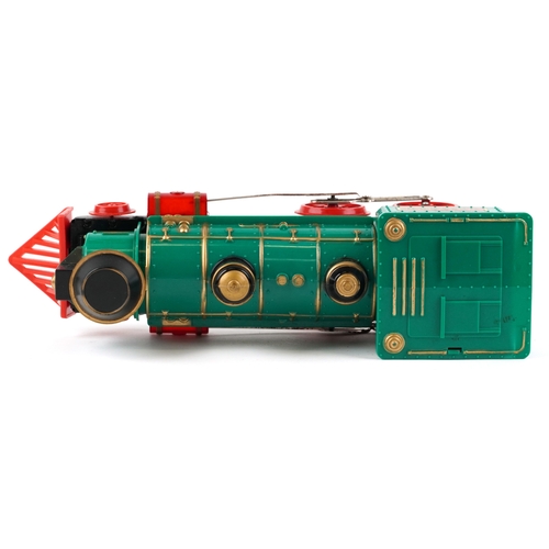 722 - A Marx whistling lighted piston locomotive battery operated plastic toy train, 33cm wide, boxed.
