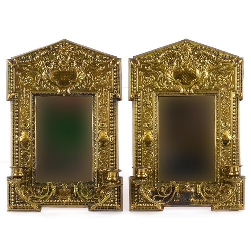 1446 - A pair of 19th century pressed brass girandole wall mirrors with embossed decoration, 38cm x 26cm.