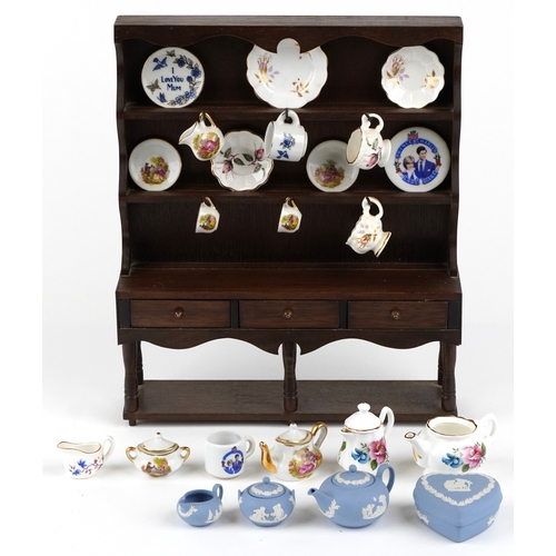 682 - Miniature collectable porcelain teaware including Wedgwood together with a diminutive mahogany dress... 