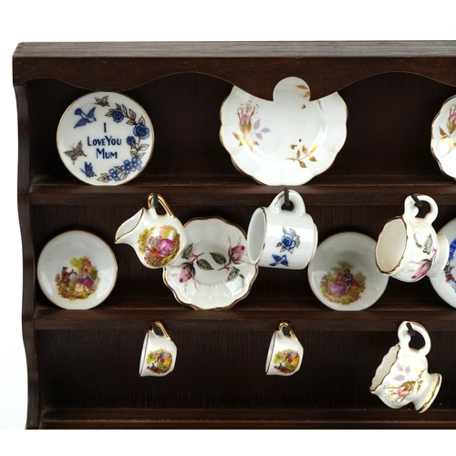 682 - Miniature collectable porcelain teaware including Wedgwood together with a diminutive mahogany dress... 