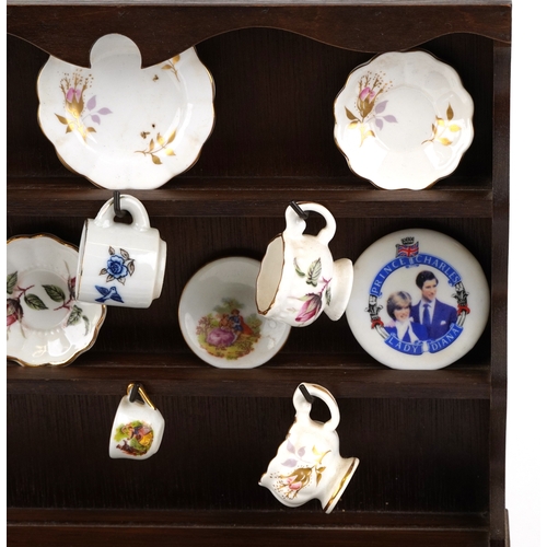 682 - Miniature collectable porcelain teaware including Wedgwood together with a diminutive mahogany dress... 
