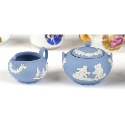 682 - Miniature collectable porcelain teaware including Wedgwood together with a diminutive mahogany dress... 