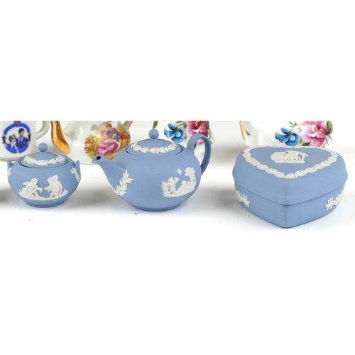 682 - Miniature collectable porcelain teaware including Wedgwood together with a diminutive mahogany dress... 