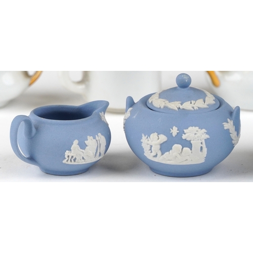 682 - Miniature collectable porcelain teaware including Wedgwood together with a diminutive mahogany dress... 