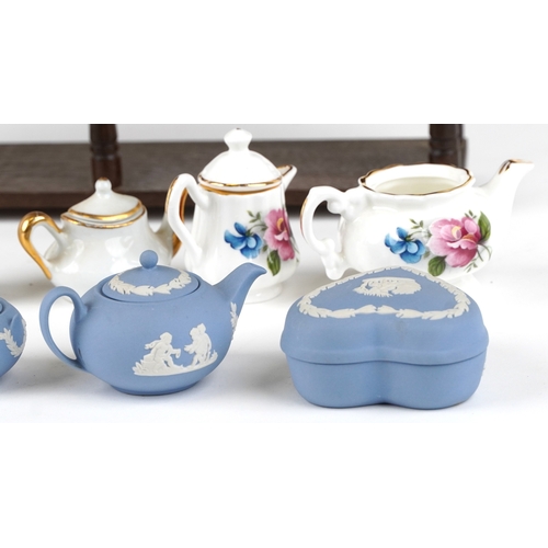 682 - Miniature collectable porcelain teaware including Wedgwood together with a diminutive mahogany dress... 
