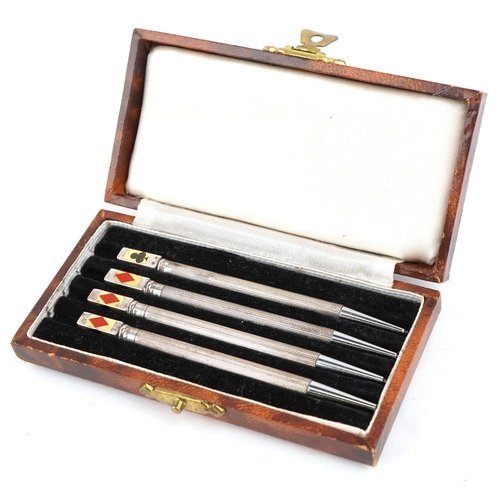 32 - Four sterling silver and enamel propelling bridge pencils housed in a fitted case, the pencils 9cm i... 