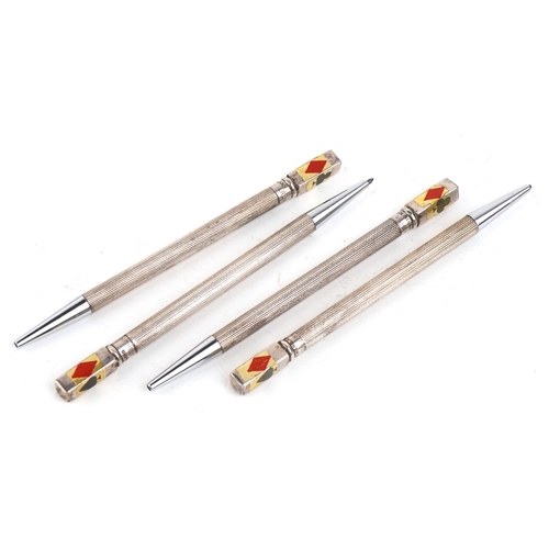 32 - Four sterling silver and enamel propelling bridge pencils housed in a fitted case, the pencils 9cm i... 