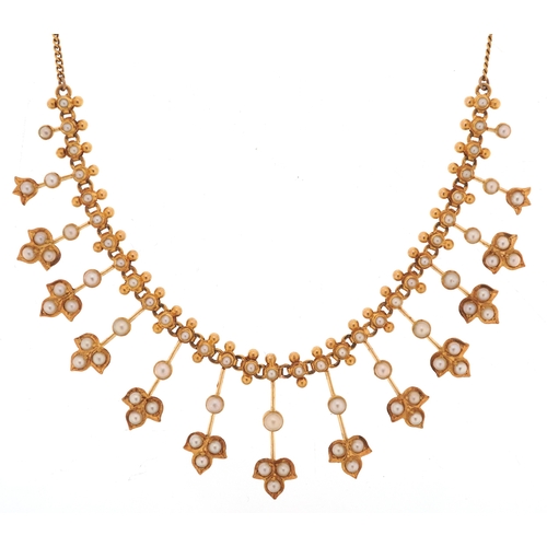 An Edwardian unmarked gold seed pearl cocktail necklace, 42cm in length, 12.8g.