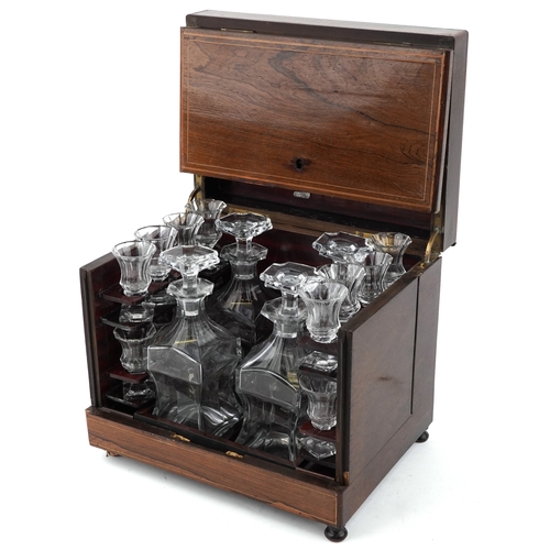 20 - An early 19th century rosewood and boxwood line inlaid table top decanter box, the hinged lid housin... 