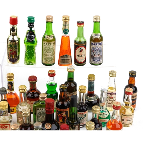 14 - A large collection of vintage and later alcohol miniatures including Martini Gin, Drambuie, Bols Che... 