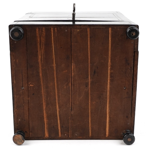 21 - A mid Victorian ebonised table top drinks cabinet with brass inlaid stringing, the hinged top reveal... 