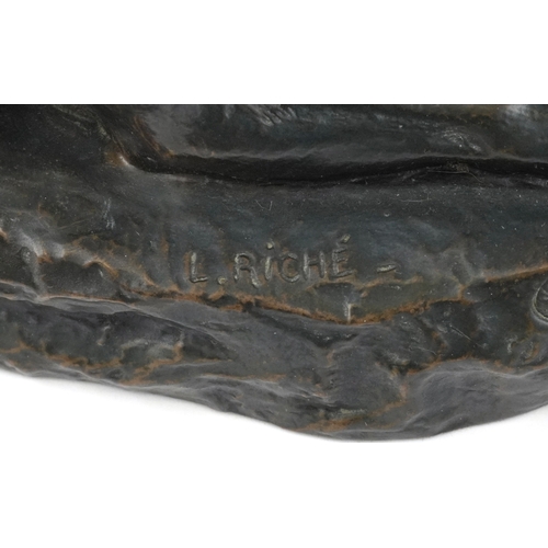 235 - After L Riché, a cold cast bronze study of a recumbent dog, 24cm in length.