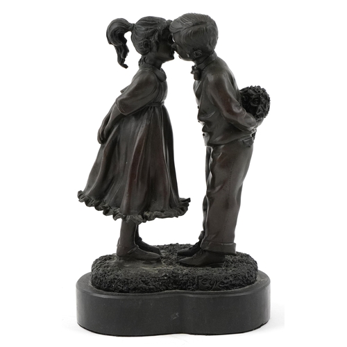 234 - After Peyre, a bronze study of a courting young boy and girl raised on a black slate base, 23.5cm hi... 