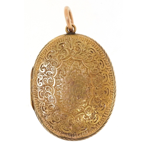 3020 - A Victorian 15ct gold locket finely engraved with foliage and an eternity belt, 3.7cm high, 9.9g.